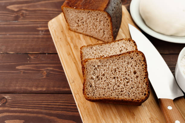 istock Sliced rye bread on brown wooden background 1297550803