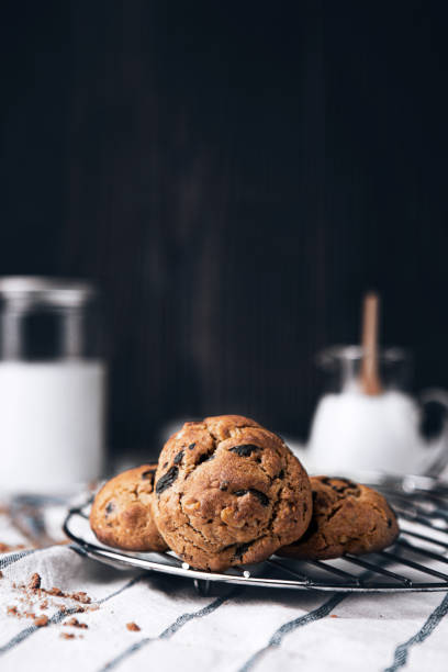 A pile of delicious chocolate cookies and mike on a white cloth.
