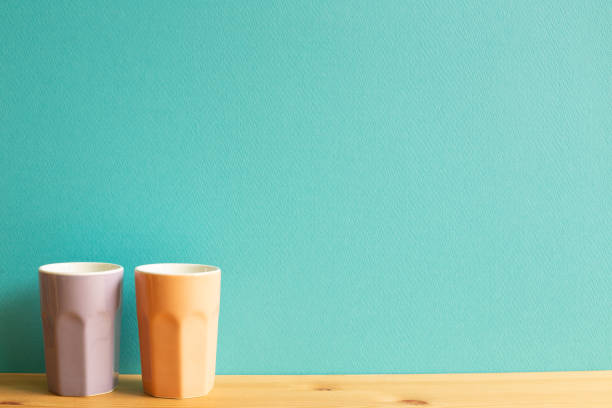 istock Colorful cups on wooden table. mint green background 1297552419