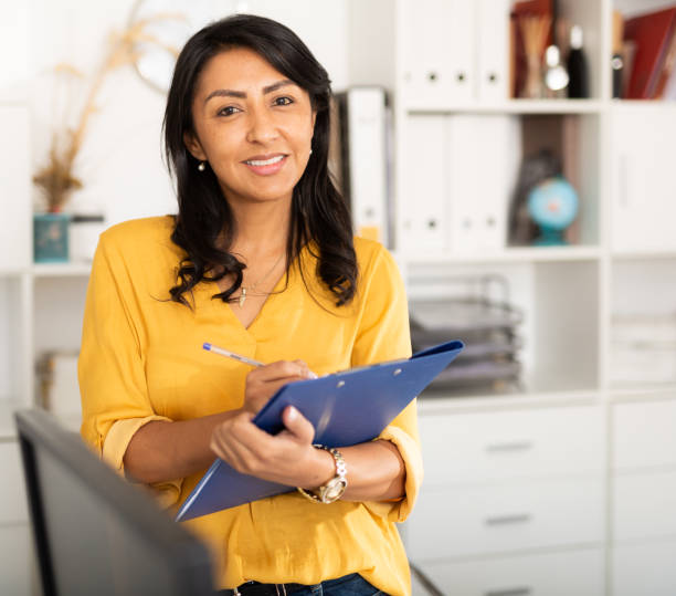 istock Businesswoman holding folder with papers, writing tasks and instructions 1297553320