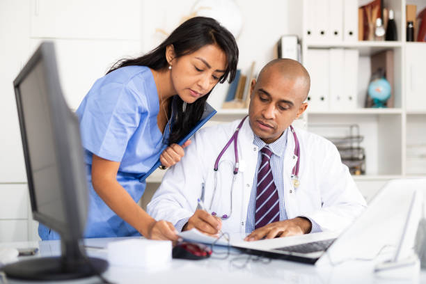 istock Doctor and nurse check patient data in hospital computer 1297553624