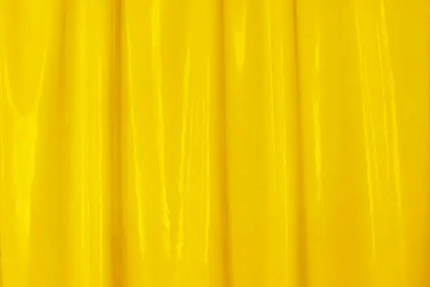 Yellow latex, soft folds, background for your design. Latex, lacquer varnish wave
