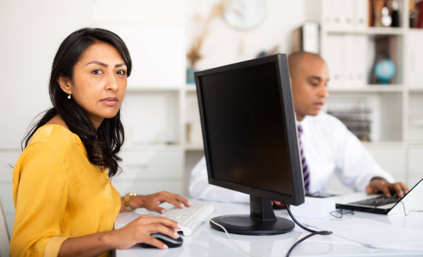istock Focused hispanic business woman working with computer in office 1297554535