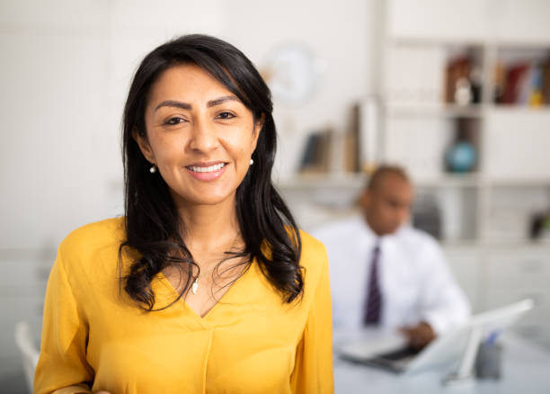 istock Smiling hispanic woman employee posing in office interior 1297554557