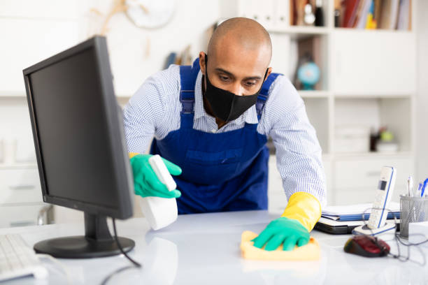 istock Professional cleaner sanitize work desk in office with cleaning disinfection 1297554733