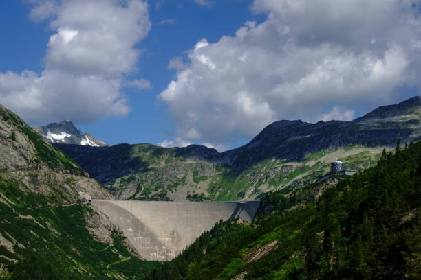 istock dam wall in a mountain valley with beautiful sky detail 1297556371