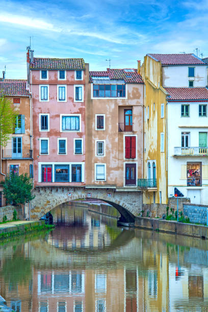 Narbonne, France Narbonne, France - houses and water canal n french town narbonne stock pictures, royalty-free photos & images