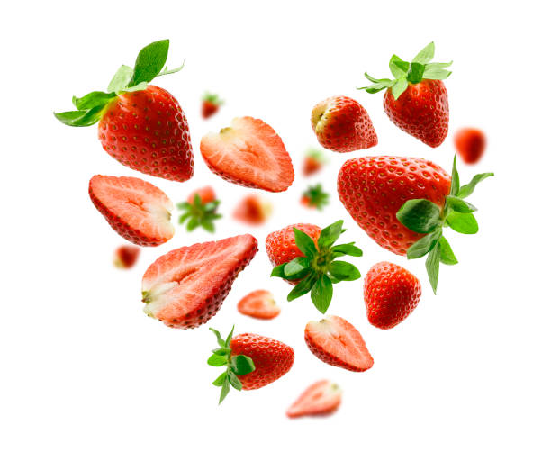 Red strawberries in the shape of a heart on a white background stock photo