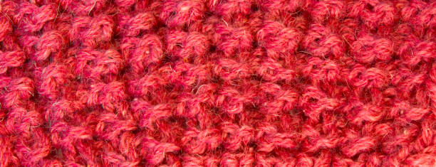 istock Knitted realistic seamless background in red color. for the text. texture with a pattern. banner. horizontal 1297557608