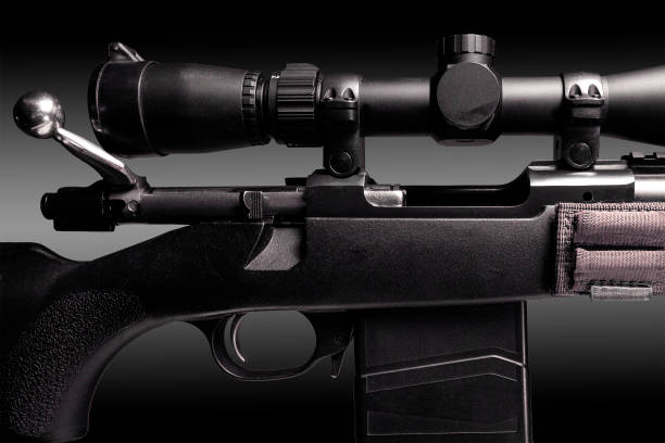 istock bolt action rifle with riflescope close up on black background, copy space 1297558947