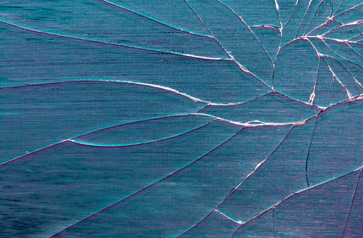 Broken mirror. Cracked glass texture on abstract background.