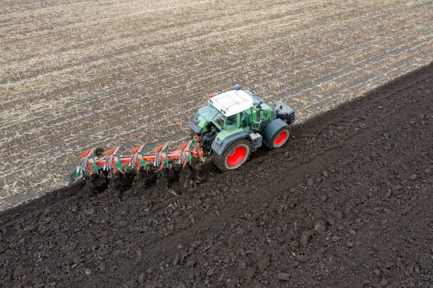 istock Top view of a tractor plowing field 1297560980