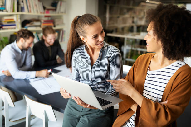 istock Working together on project. Happy young business colleagues working in office 1297561874