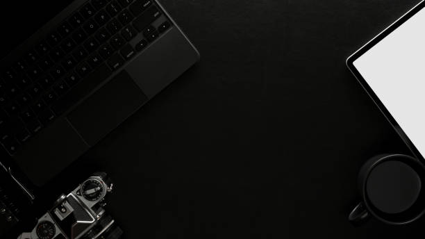 istock Workspace with tablet, camera, supplies and copy space in home office room 1297563576