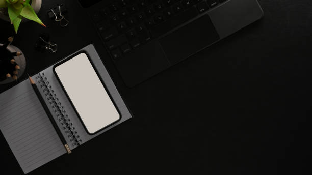 istock Top view of worktable with smartphone, stationery, laptop keyboard 1297564236