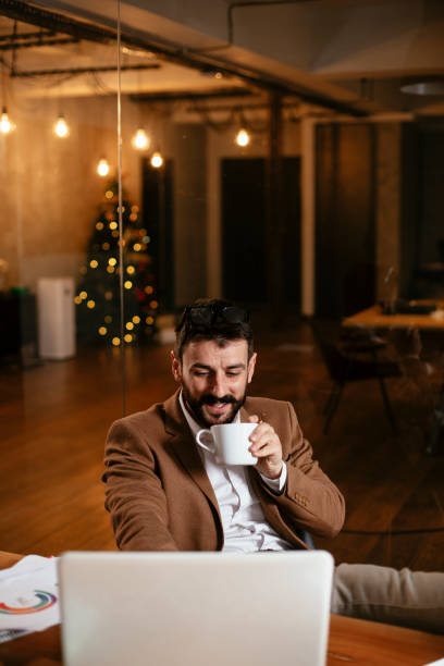 istock Young businessman drinking coffee in the office. 1297565628