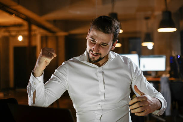 istock Businessman sitting at office desk working on laptop computer 1297566570