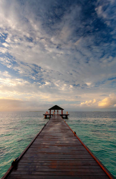 On Pier In The Maldives At Sunset