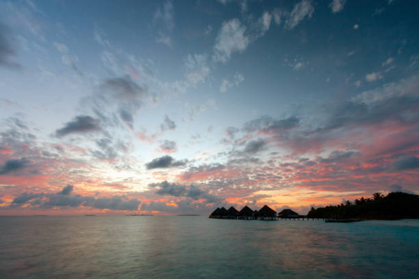 istock Water Bungalows At Dawn In The Maldives 1297568207