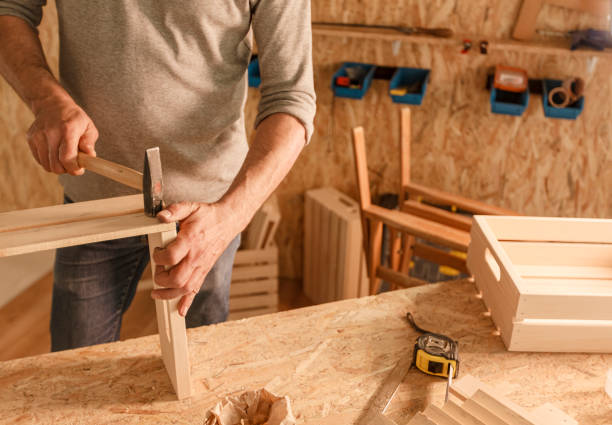 istock Carpenter hammering planks together and making a wooden crate 1297568550