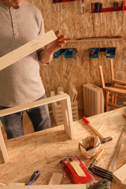 istock Carpenter making a wooden crate in his workshop 1297569325