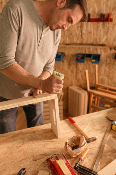 istock Gluing together planks to make a wooden crate 1297569334
