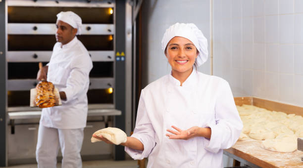 istock Woman baker demonstrates ready dough for baking in oven 1297569746