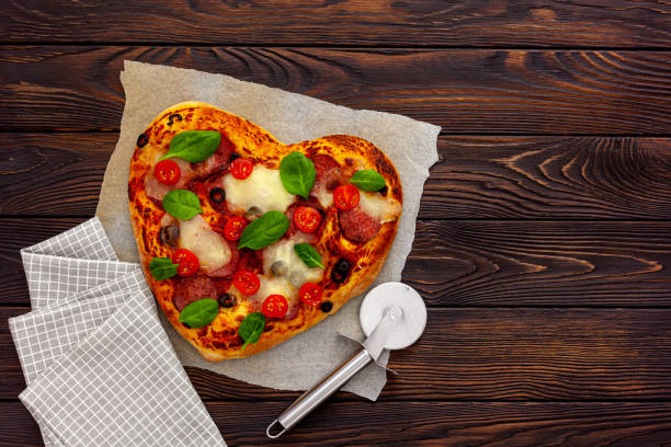 istock Heart shaped pizza for valentine's day 1297570777