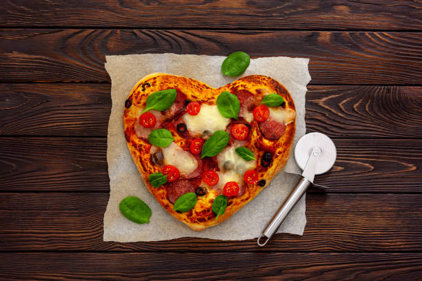 istock Heart shaped pizza for valentine's day 1297570795