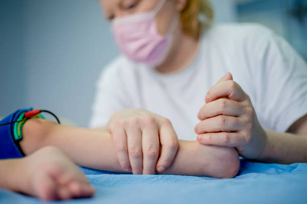 istock Physiotherapist doing with child exercise for feet 1297571985