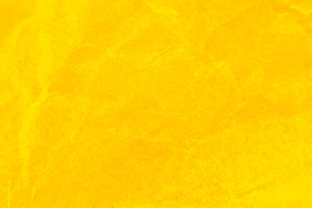 Crumpled yellow paper background. Real macro battered texture. Close up photo.