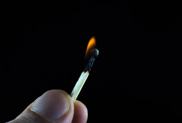 istock Burning match in a man's hand. New idea concept. 1297573813