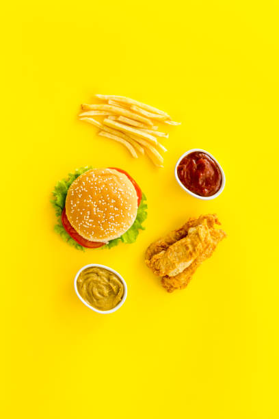 istock Fast food flat lay set. Burger with fried potatoes and chicken, top view 1297576437