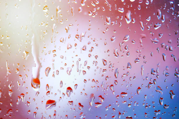 istock rain droplets on glass over calm colorful background. abstract colorful rainy backdrop 1297576888