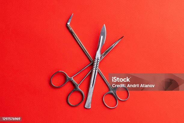 Medical Equipment For Surgery Over Red Desk Background With Copy Space Surgery Concept Stock Photo - Download Image Now