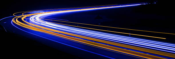 istock orange and blue car lights at night 1297577695