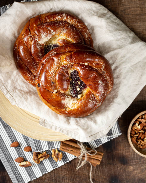 istock Buns with jam on a wooden table. Pie with cherry jam and marzipan. Rustic delicious pastries 1297579469