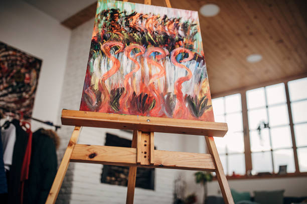 istock Modern painting on easel in empty apartment 1297579641