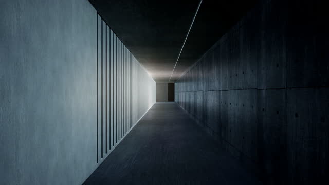 A dark, empty corridor, illuminated by the rays of the rising sun through the columns