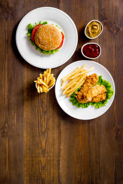 istock Burger with fried potatoes and chicken, top view 1297580085