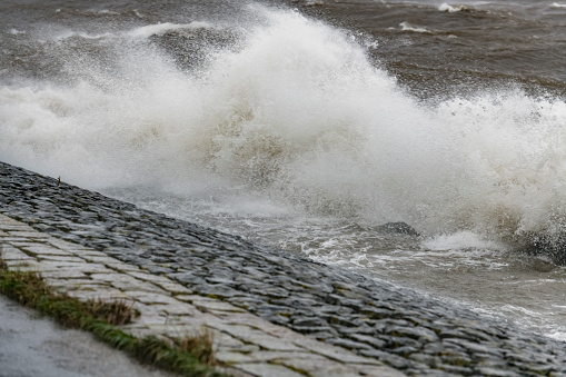 Waves hitting a levee at the IJsselmeer in Flevoland, The Netherlands, during a storm in january