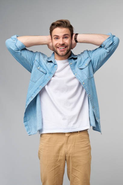 istock young man with ears closed standing over grey studio background 1297581433