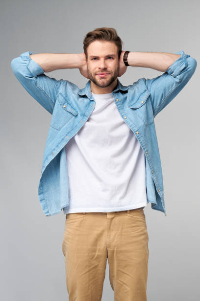istock young man with ears closed standing over grey studio background 1297581434