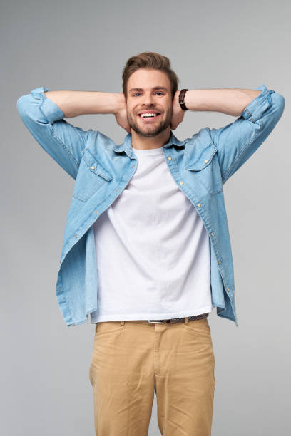 istock young man with ears closed standing over grey studio background 1297581447