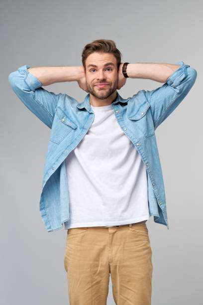 istock young man with ears closed standing over grey studio background 1297581456