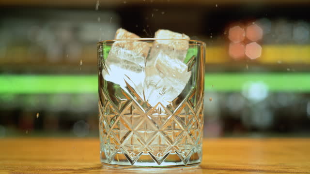 SLO MO DS Ice cubes falling into a rocks glass