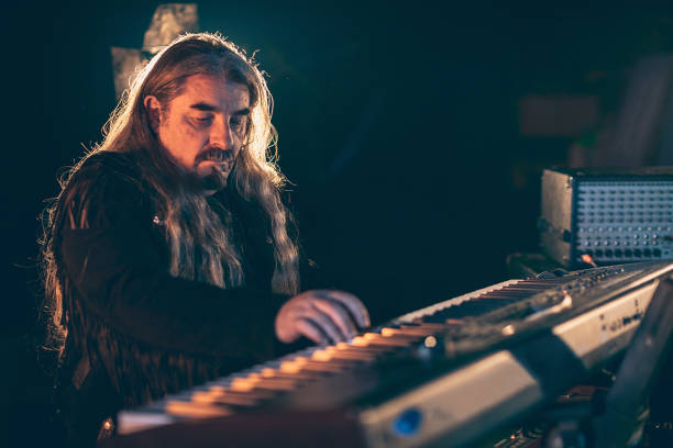 istock Rock musician playing keyboard on stage 1297585116