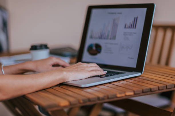 istock close up. businesswoman using a laptop to work with financial data 1297585383