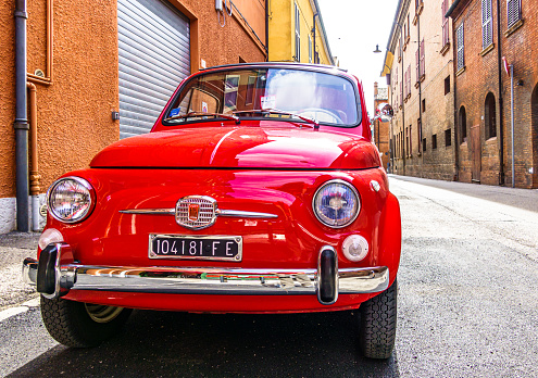 Bologna, Italy - October 6: old classic car Fiat 500 at a street in the old town of Bologna on October 6, 2020