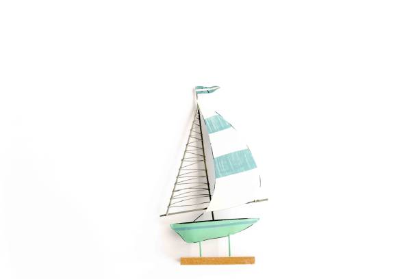 istock Miniature toy boat on white background. Flat lay, top view 1297586488